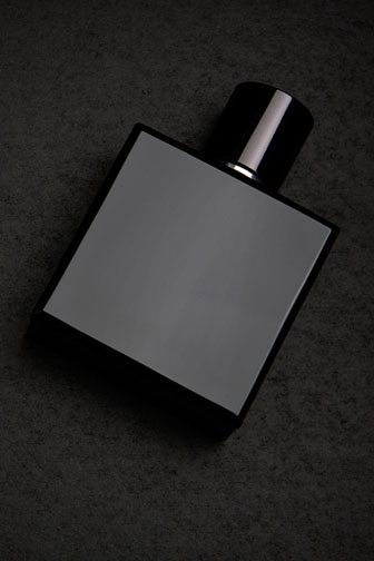 square cologne bottle on a black background